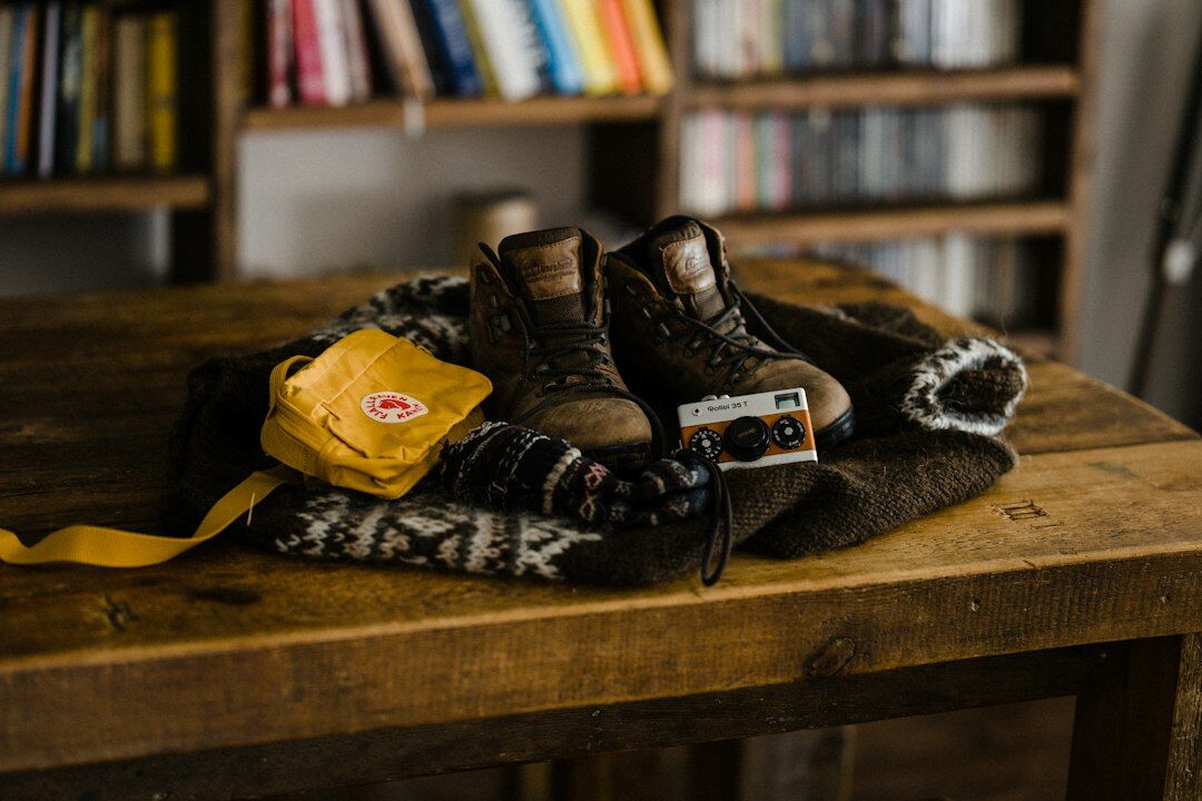 Vintage film cameras and photo archive boxes on a wooden table