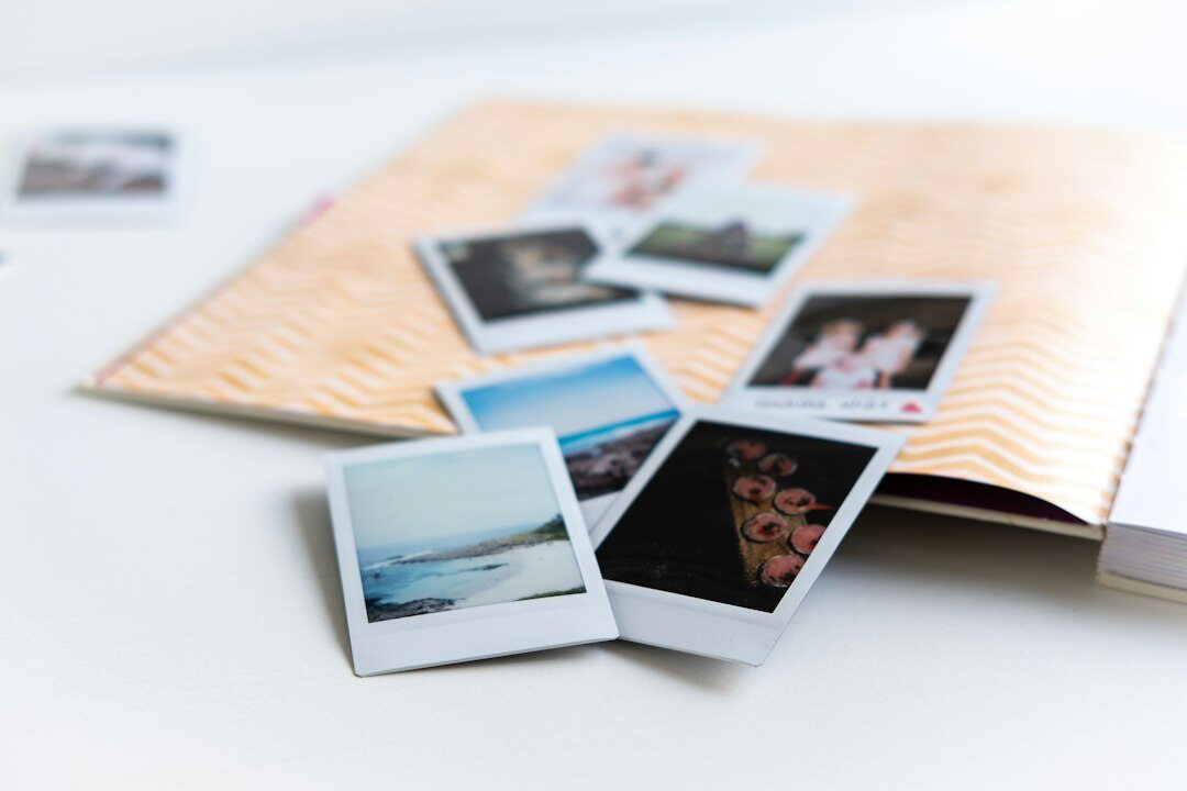 Journalist reviewing printed photographs and notes on a desk